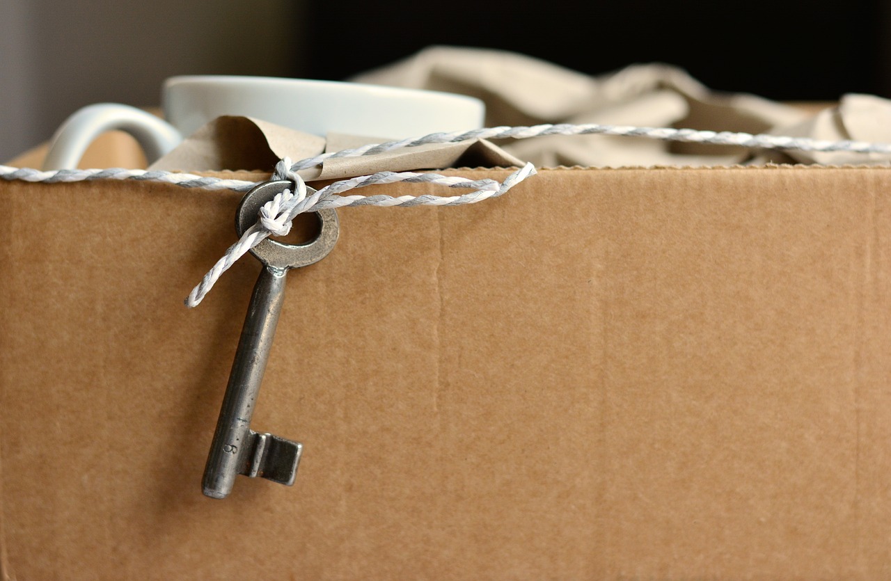 Cardboard box containing a mug and a key